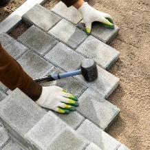 Hands Of A Worker Installing Concrete Blocks Pavi 2023 01 05 01 40 39 Utc